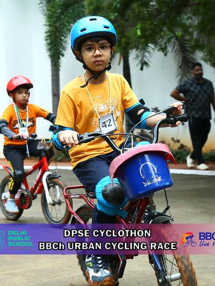 Two young riders, one with a basket on their bike, show that all types of bicycles are welcome in our youth races. It's all about the joy of riding and competing.