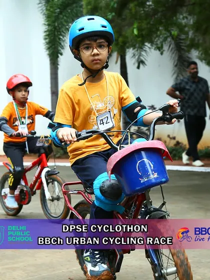 Two young riders, one with a basket on their bike, show that all types of bicycles are welcome in our youth races. It's all about the joy of riding and competing.