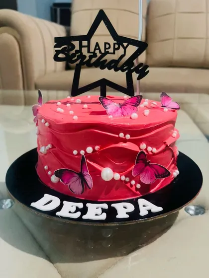 This vibrant pink cake is all about fun and flair. Decorated with bright pink butterflies and pearls, it's a bold and cheerful choice for someone who loves a pop of colour.