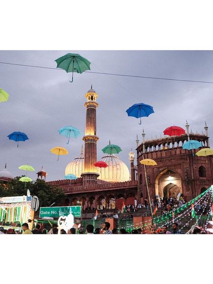 The Jama Masjid decorated with colorful floating umbrellas in preparation for the G20 summit. This image captures a unique and festive look for the historic monument.