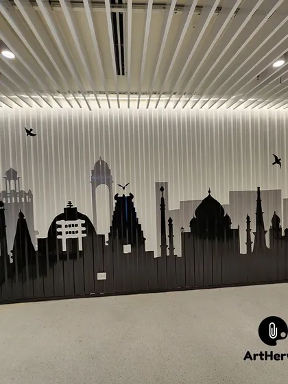 We can paint on any surface, including this unique metal shed wall in a Gurgaon office. This striking black and grey silhouette of Indian monuments creates a sophisticated and modern mural that adds depth and character to the workspace.