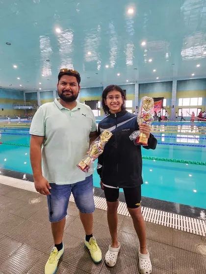 Two swimmers, two 'Best Performance' trophies. Prapti Ghose holding her awards after she and a teammate brought home 8 gold medals from the SGFI State Championship.