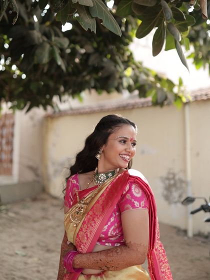 A beautiful candid of the bride during her Ganesh Poojan, embodying the grace of Radha.