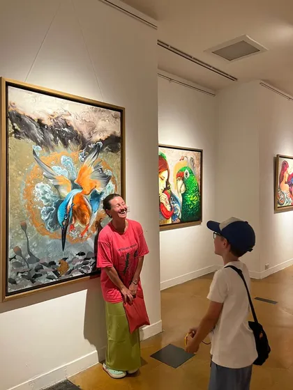 Visitors enjoying the art at my exhibition. I love seeing people of all ages connect with the paintings, each finding their own meaning in the work.