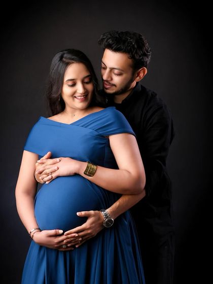 An intimate close-up showing the couple's connection. The way they look at each other while cradling the bump speaks volumes about their shared journey.