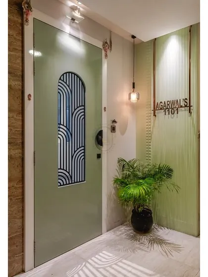 The main entrance sets the tone for the entire home. I designed this custom door in a calming sage green, featuring a unique glass insert with an art deco-inspired pattern. Paired with a fluted wall panel, a custom nameplate, and warm lighting, it creates a welcoming and memorable first impression.