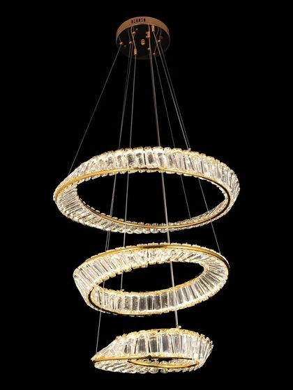 A modern pendant light with three tiers of crystal-encrusted rings. This elegant fixture combines the clean lines of modern design with the timeless sparkle of crystal, ideal for a chic living space.