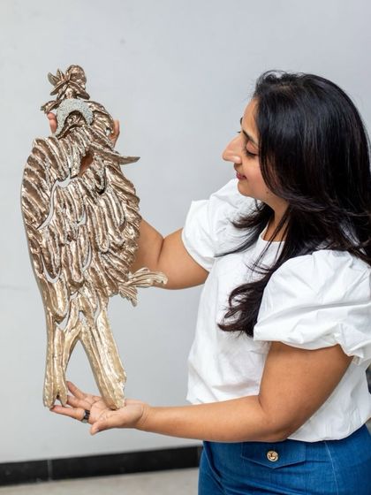 Another angle of me holding "The Bronze Guardian," showcasing its three-dimensional form and detailed craftsmanship.