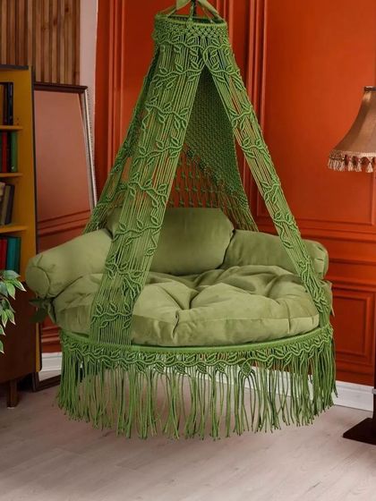 This green chair swing is perfect for a study or library. The color is vibrant and adds a refreshing touch to the room.