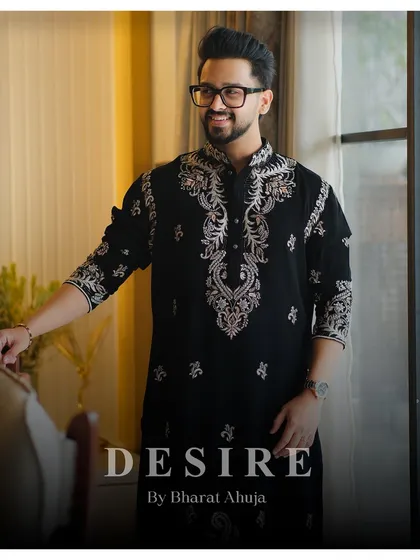 Elegance is an attitude. This classic black kurta is transformed by intricate silver and gold embroidery around the collar and down the placket. It is a versatile piece of luxury menswear, designed for moments that matter.