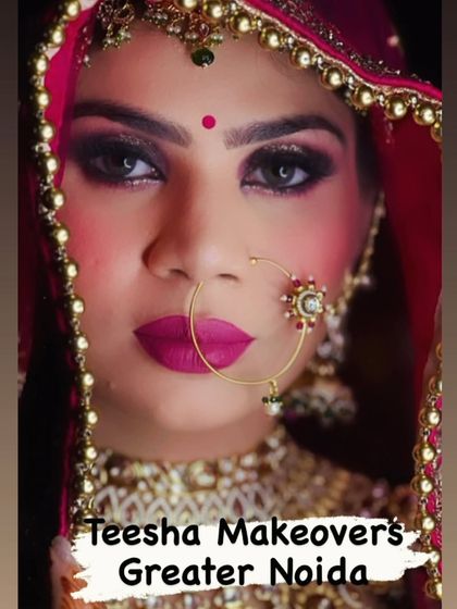 A powerful close up of a bride, with her face framed by the dupatta. The focus is on her intense eyes and bold lip.
