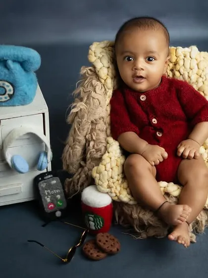Taking care of business. This 'Baby Boss' setup is a hilarious and creative theme for a sitter session, complete with a miniature desk, phone, and even a tiny cup of coffee.