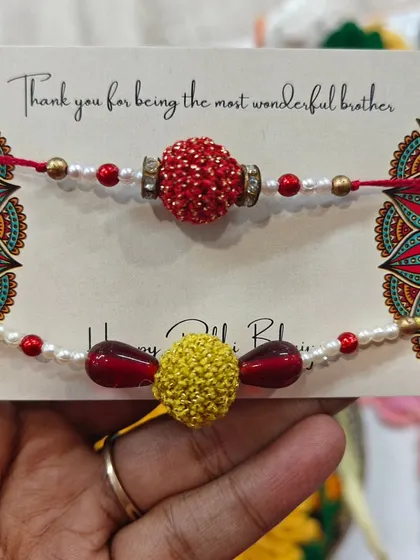 A set of elegant rakhis featuring beadwork and crochet centers. These designs blend traditional elements with handmade charm.