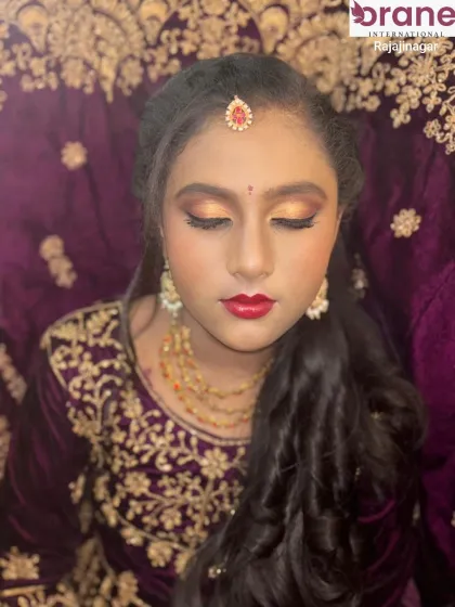 A traditional lehenga look perfect for a North Indian wedding ceremony. The makeup features golden eyes and a classic red lip.