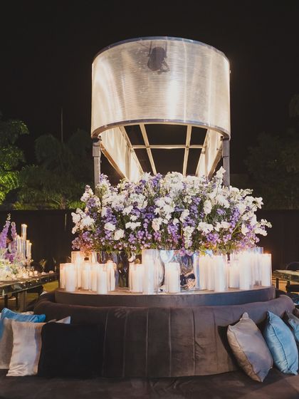 A custom-designed seating area inspired by a rocket engine, complete with plush cushions and a large floral arrangement, tying into the 'Interstellar' theme.
