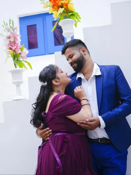 An intimate and happy moment at our Santorini-themed set. The bride's purple gown and the groom's blue suit create a lovely color palette.