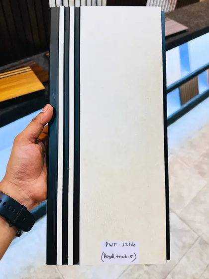 The 'royal touch' cream-colored fluted panel, held in hand to show its profile and solid construction.