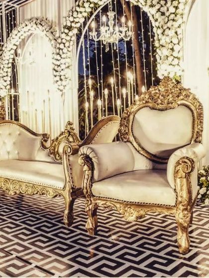 The luxurious textures and classic design of the stage furniture provide a regal setting for wedding photographs.