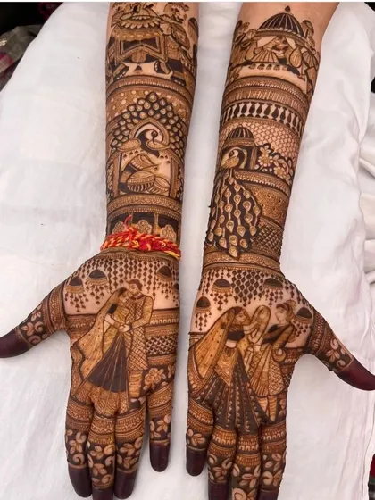 A romantic dance pose is featured on the palms, while the forearms are decorated with peacock and palace jharokha (window) designs, creating a fairytale look.
