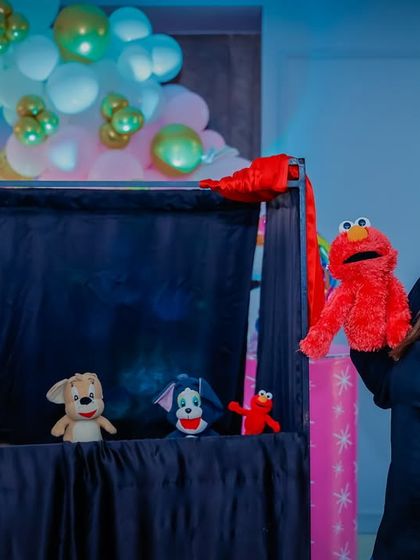 The full puppet show setup, with the puppeteer and her cast of characters ready to entertain the party guests.