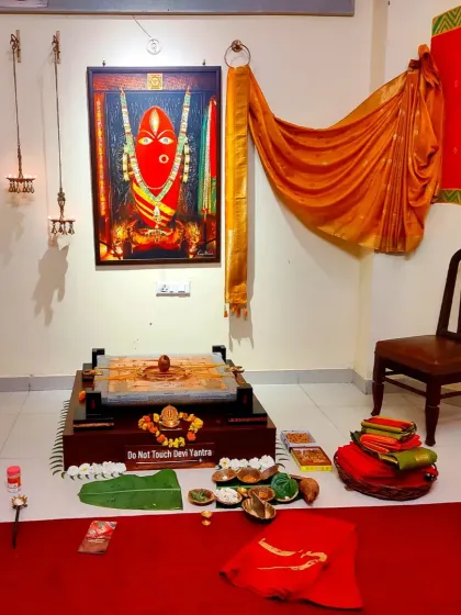 The Devi's abode prepared for Dhanya Purnima. Offerings of sarees and other sacred items are placed before her, each one an expression of devotion from our community.