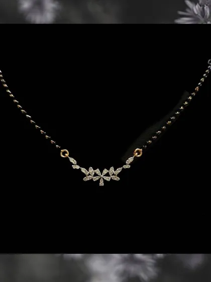 A very delicate design for daily wear. This mangalsutra features a small cluster of marquise-cut diamonds, offering a subtle sparkle that is perfect for everyday elegance.