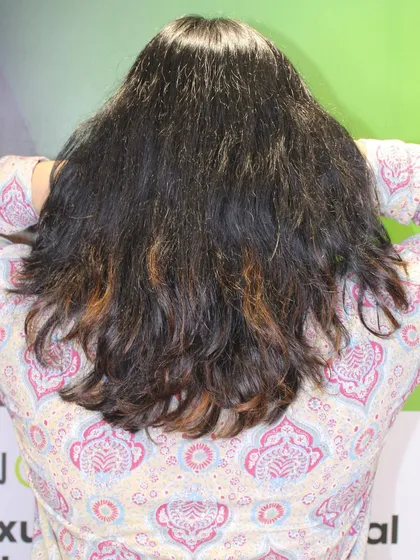 The "before" shot, showing dark, frizzy hair ready for a wonder blonde transformation.