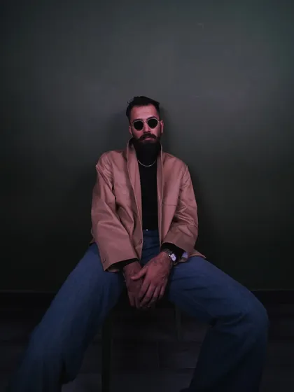 Layering a tan jacket over the turtleneck adds another dimension to the classic look. This full-body pose shows how I can model different apparel combinations in a studio setting.