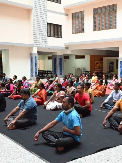 No group is too large. I have had the pleasure of hosting sessions for big university events, turning Yoga Day into a proper 'habba' or festival. This image captures a large group of university staff engaging in a guided relaxation exercise.