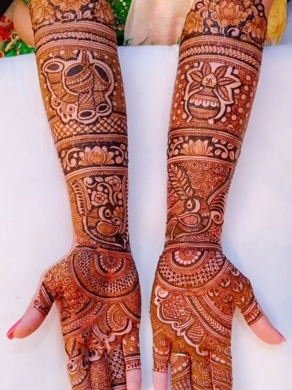 A rich and dense bridal design filled with traditional Indian motifs like the kalash, peacock, and intricate filler patterns, perfect for a traditional ceremony.