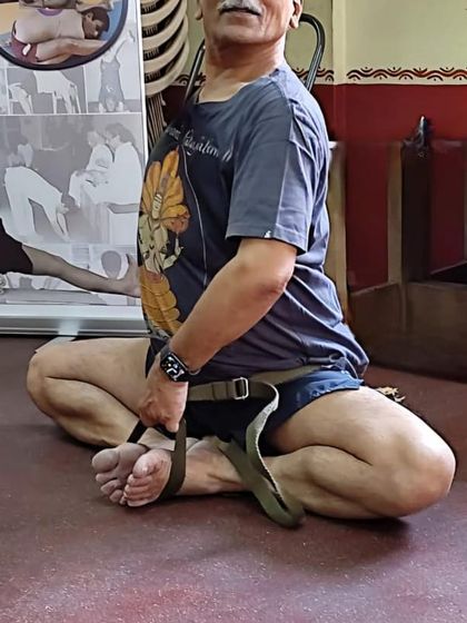 A seated pose with a strap.