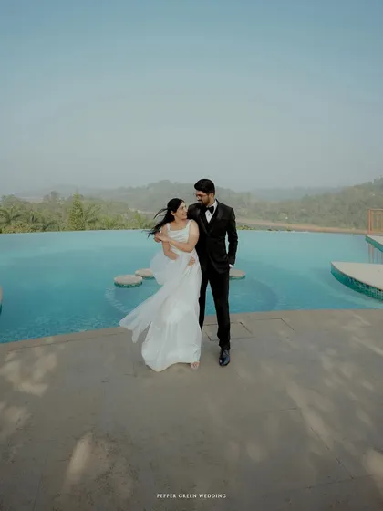 A modern and romantic portrait by an infinity pool, the vastness of the water and sky adding to the epic feel of their wedding day.