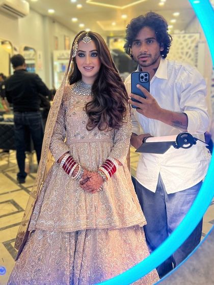 A mirror selfie with the bride. Her glamorous open waves are the perfect choice for her modern peplum lehenga.