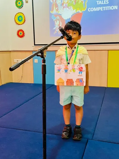 A student presents his story of "The Three Little Pigs" during our tale-telling competition. This activity helps children practice their memory, sequencing, and presentation skills.