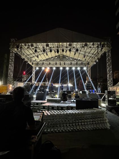 A shot of the empty stage during soundcheck, showing the scale of the production for a large outdoor concert.