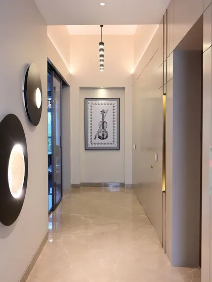 A hallway in a completed project, where I used a combination of wall sconces and recessed ceiling lights to create a bright and welcoming path.