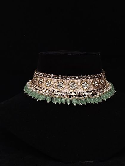A delicate choker with mint green beads and Polki work.