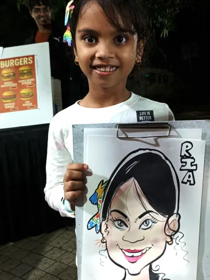 This young girl's bright smile matches her colorful caricature. It's a joy to draw for such an enthusiastic audience.