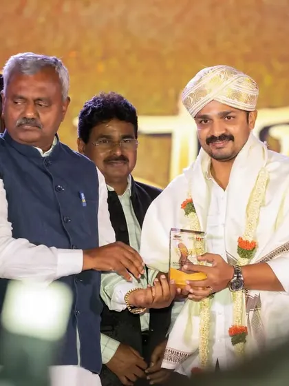 Capturing an awards presentation with actor Vijay Raghavendra at the 'Kasinasara' audio launch. Our event photographers are skilled at getting clean shots of key interactions during formal proceedings.