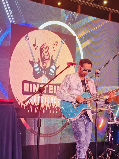Our lead guitarist performing in front of our band logo at the SBI corporate event.