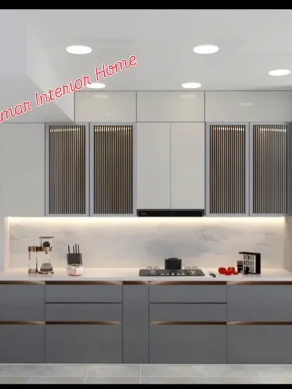A closer look at the grey modular kitchen, showing the handleless drawers and the seamless integration of the hob and chimney.