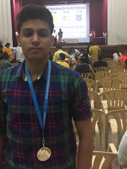 A close-up of a student with his medal at the Indian Revenue Open Shooting Championship.
