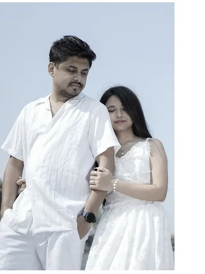 A portrait from a pre-wedding shoot with the couple dressed in all white, creating a serene and classic look.