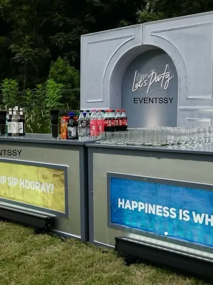 A custom bar setup for an adult's party, featuring fun, illuminated signs. This shows how I can create functional and themed elements for any type of celebration.