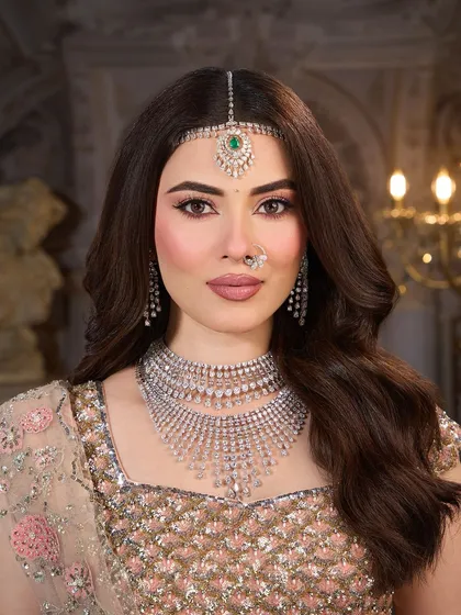 A close up on the soft, romantic makeup. The eyes are defined with a gentle winged liner and the skin is given a luminous, pearlescent glow.