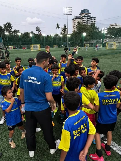 A sports psychologist interacts with an energetic group of young players. These sessions are designed to be engaging and fun, making learning about sports psychology accessible for all ages.