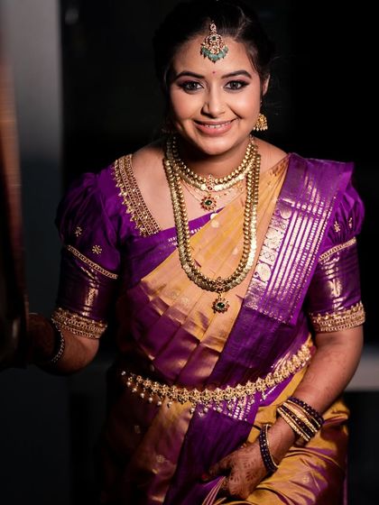 A smiling portrait of Varshini, showcasing her complete varpuje look.