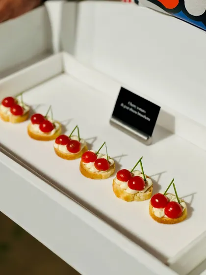 A playful and creative canapé from our Hello Kitty themed menu for the brand péro. These cherry tomato and goat cheese bruschetta bites were designed to look like cherries, adding a whimsical touch to the event.