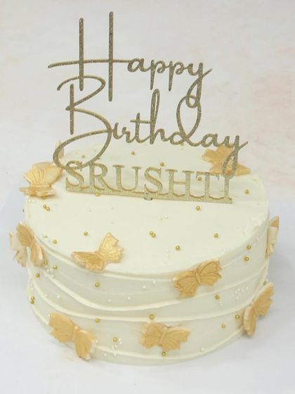 Another view of the elegant white and gold butterfly cake.