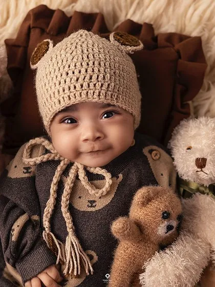 A sweet and gentle smile from this little one, nestled amongst his teddy bear friends. These simple, classic portraits are truly timeless.
